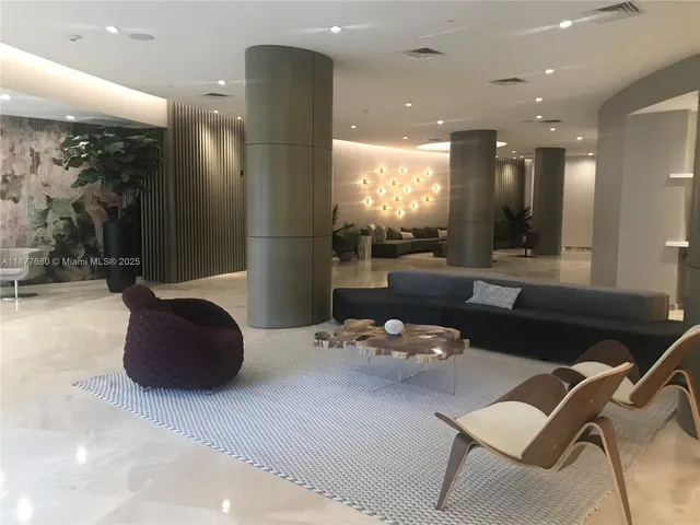 a living room with a table and chairs