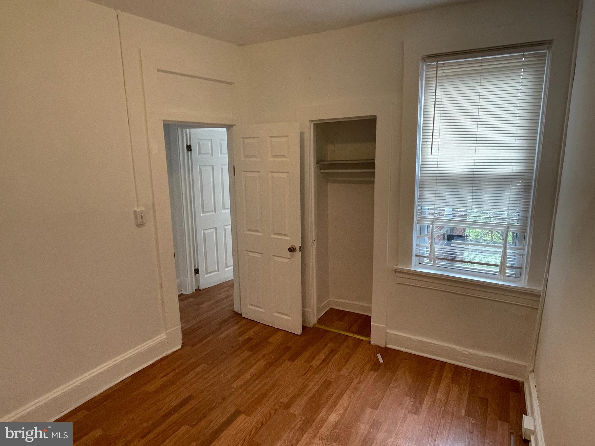 1314 Division Street Baltimore, MD 21217 - Photo 12 of 20 an empty room with wooden floor and windows