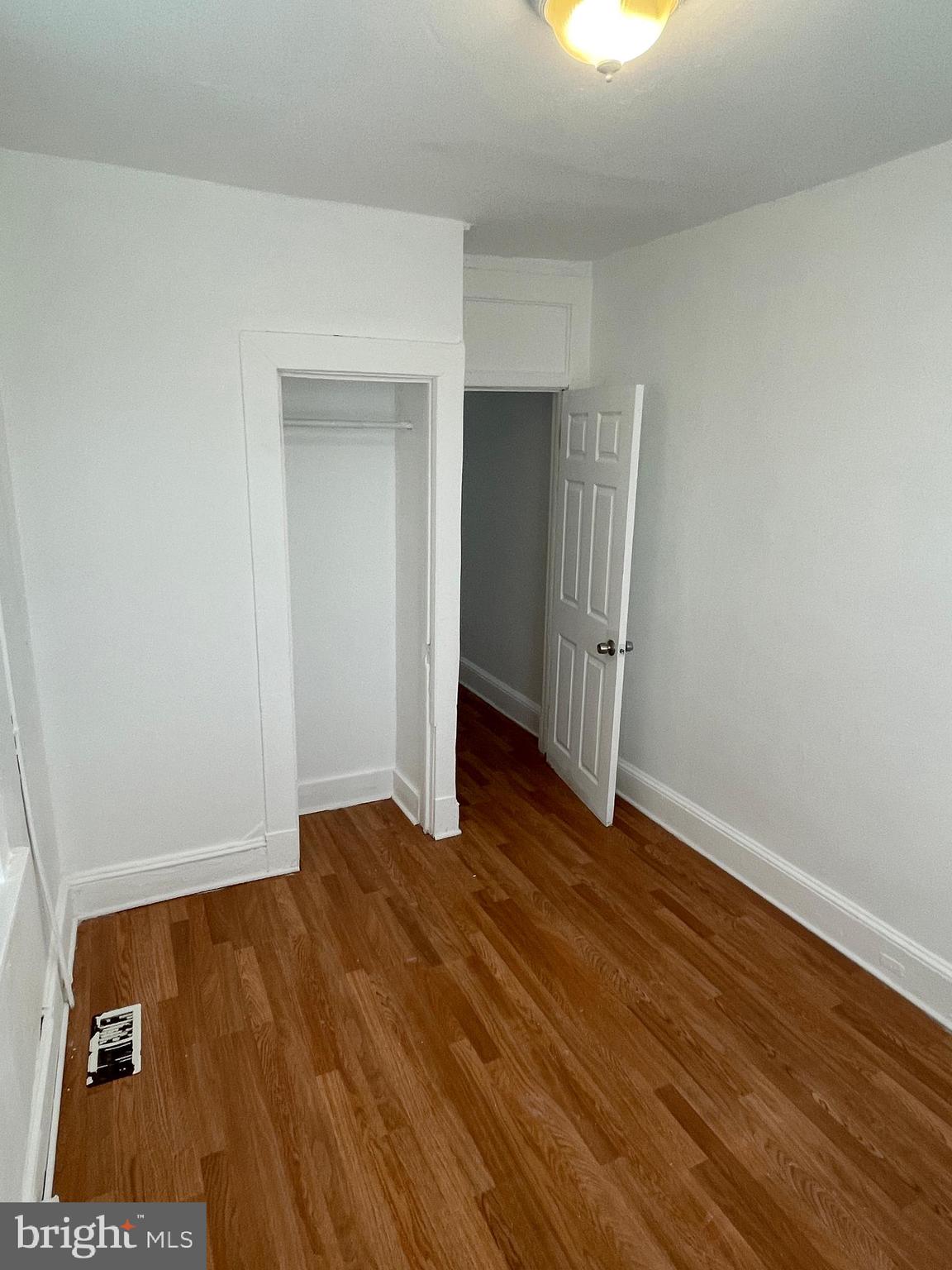 1314 Division Street Baltimore, MD 21217 - Photo 13 of 20 an empty room with wooden floor and closet