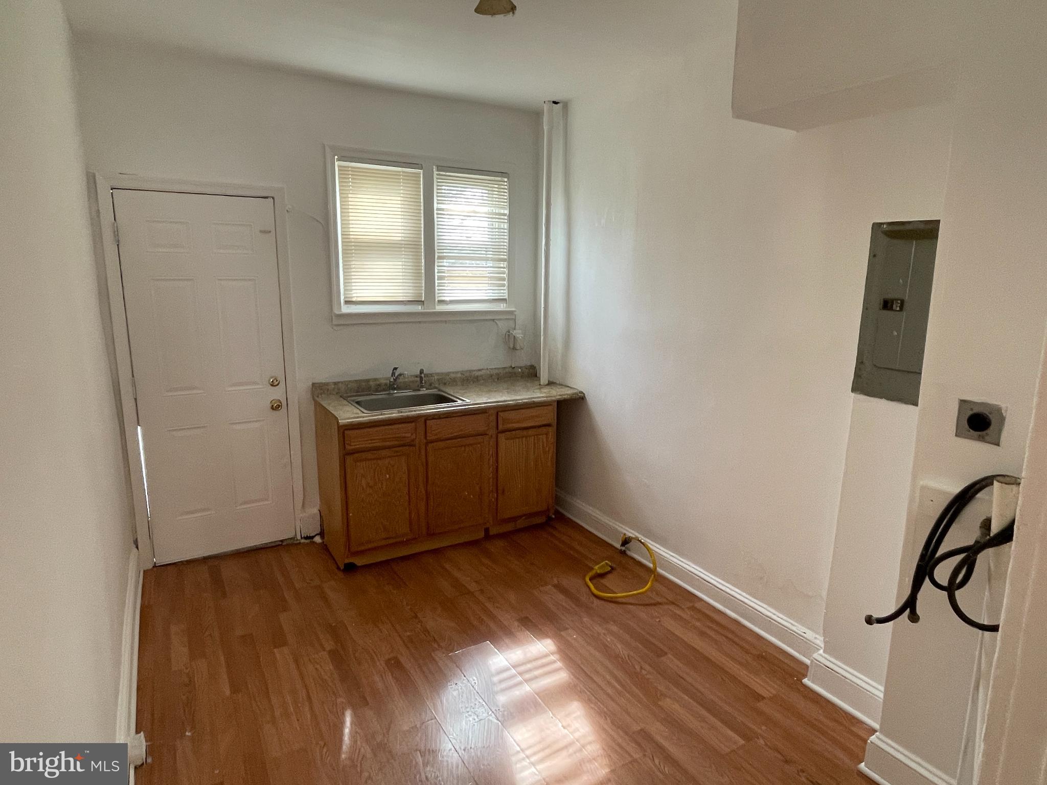 1314 Division Street Baltimore, MD 21217 - Photo 6 of 20 a room with a wooden floor and a window