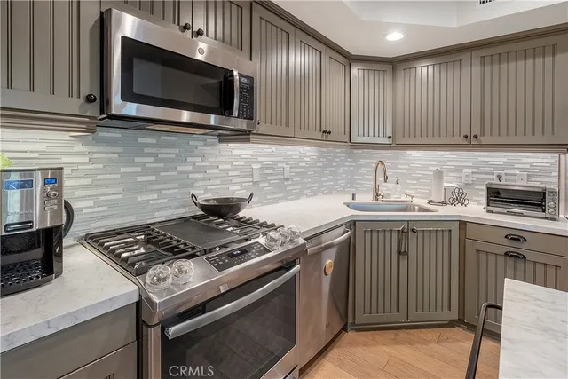 a kitchen with stainless steel appliances a sink stove and microwave