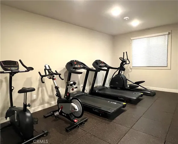 a room with gym equipment and windows