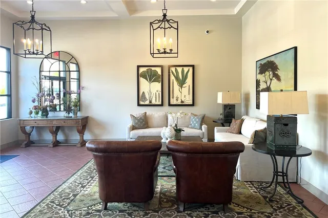 a living room with couches a dining table with fireplace and cabinet