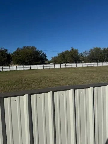 a view of a yard with large trees