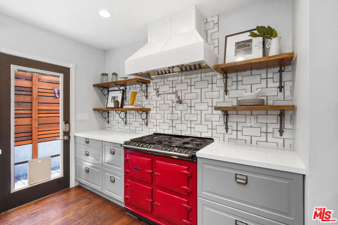 1774 Washington Way Venice, CA 90291 - Photo 13 of 42 a kitchen with stainless steel appliances a stove and a cabinets