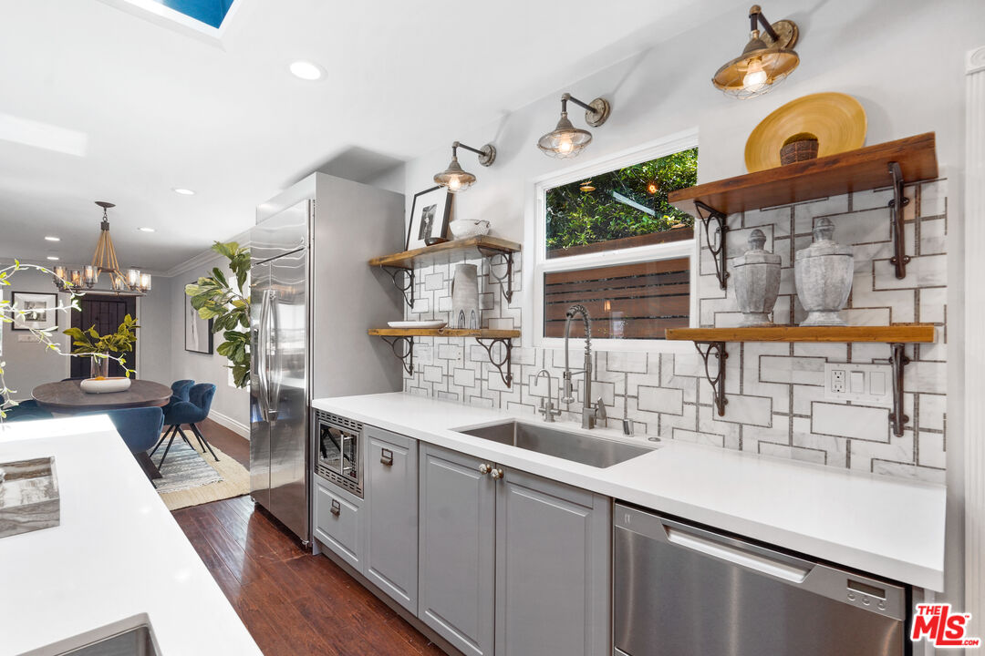 1774 Washington Way Venice, CA 90291 - Photo 15 of 42 a kitchen with a sink stove and cabinets