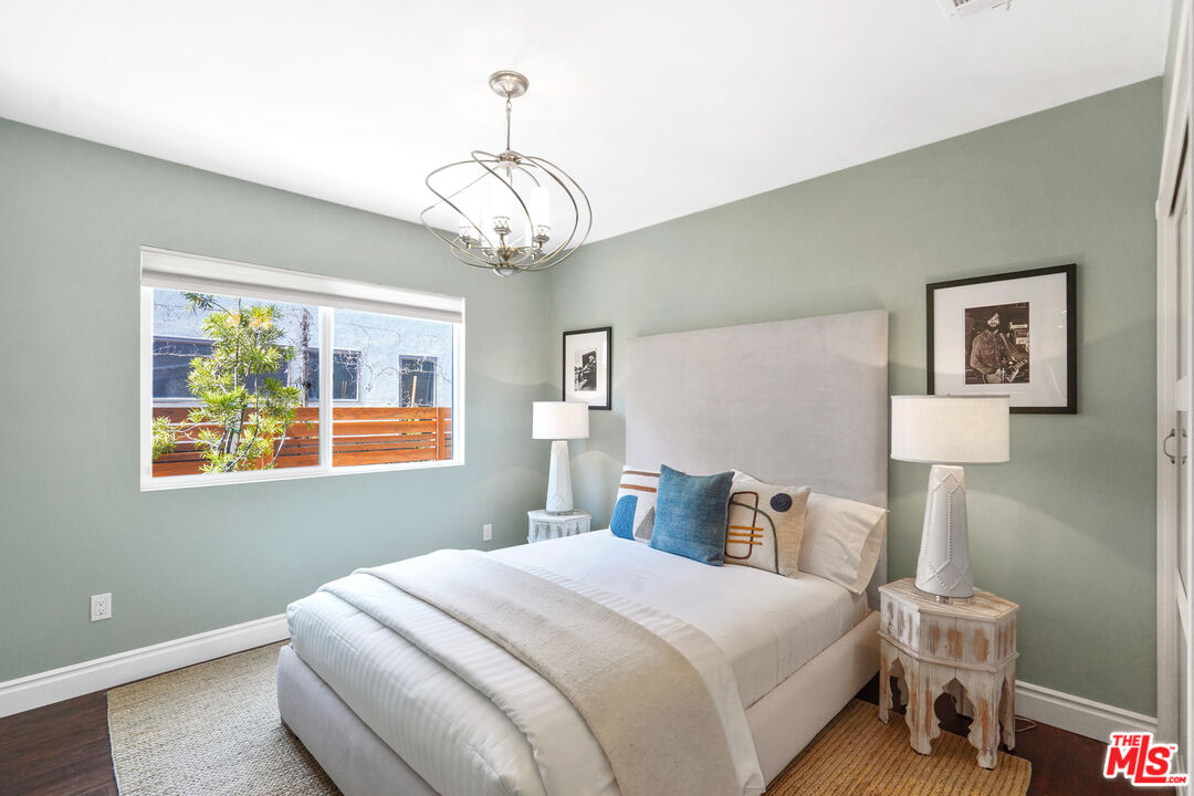1774 Washington Way Venice, CA 90291 - Photo 16 of 42 a bedroom with a bed and a chandelier