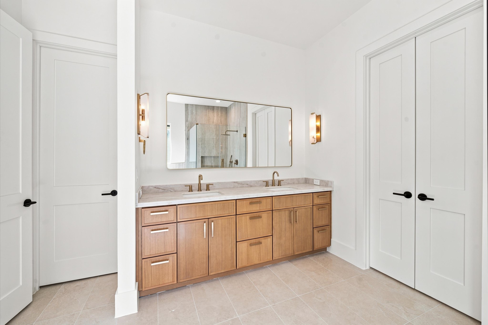 112 East 27th Street Houston, TX 77008 - Photo 20 of 43 White oak cabinetry and quartz countertops enhance the vanity in the primary bathroom.