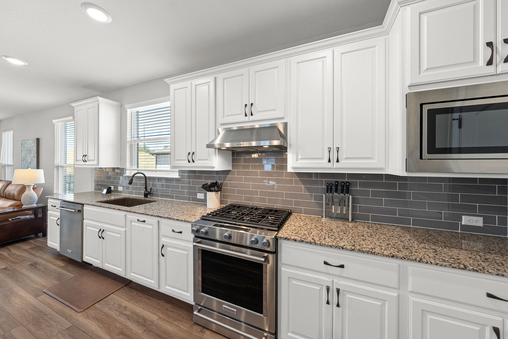 642 Martingale Street Georgetown, TX 78633 - Photo 13 of 40 The kitchen features an upgraded appliance package with stainless steel appliances, including a high-end gas range and a built-in microwave.