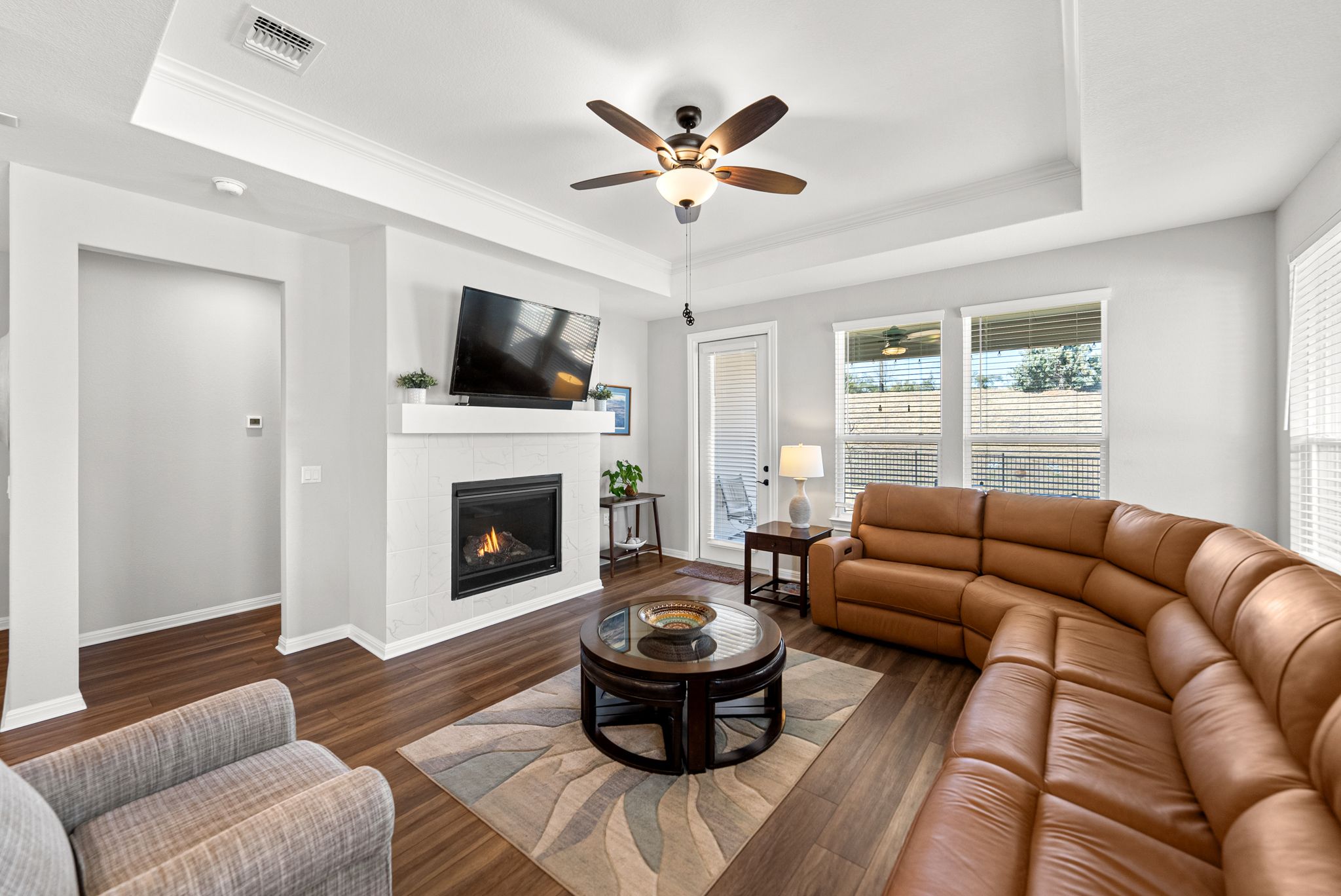 642 Martingale Street Georgetown, TX 78633 - Photo 15 of 40 Relax by the fire in this spacious great room. The elegant gas fireplace is the focal point, while large windows flood the space with light and provide views to your private outdoor space.
