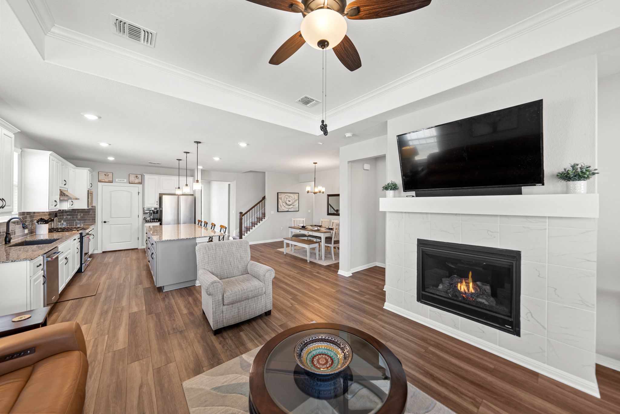 642 Martingale Street Georgetown, TX 78633 - Photo 16 of 40 There is a seamless transition between the gourmet kitchen, dining area, and living room, all tied together by beautiful and durable LVP flooring.