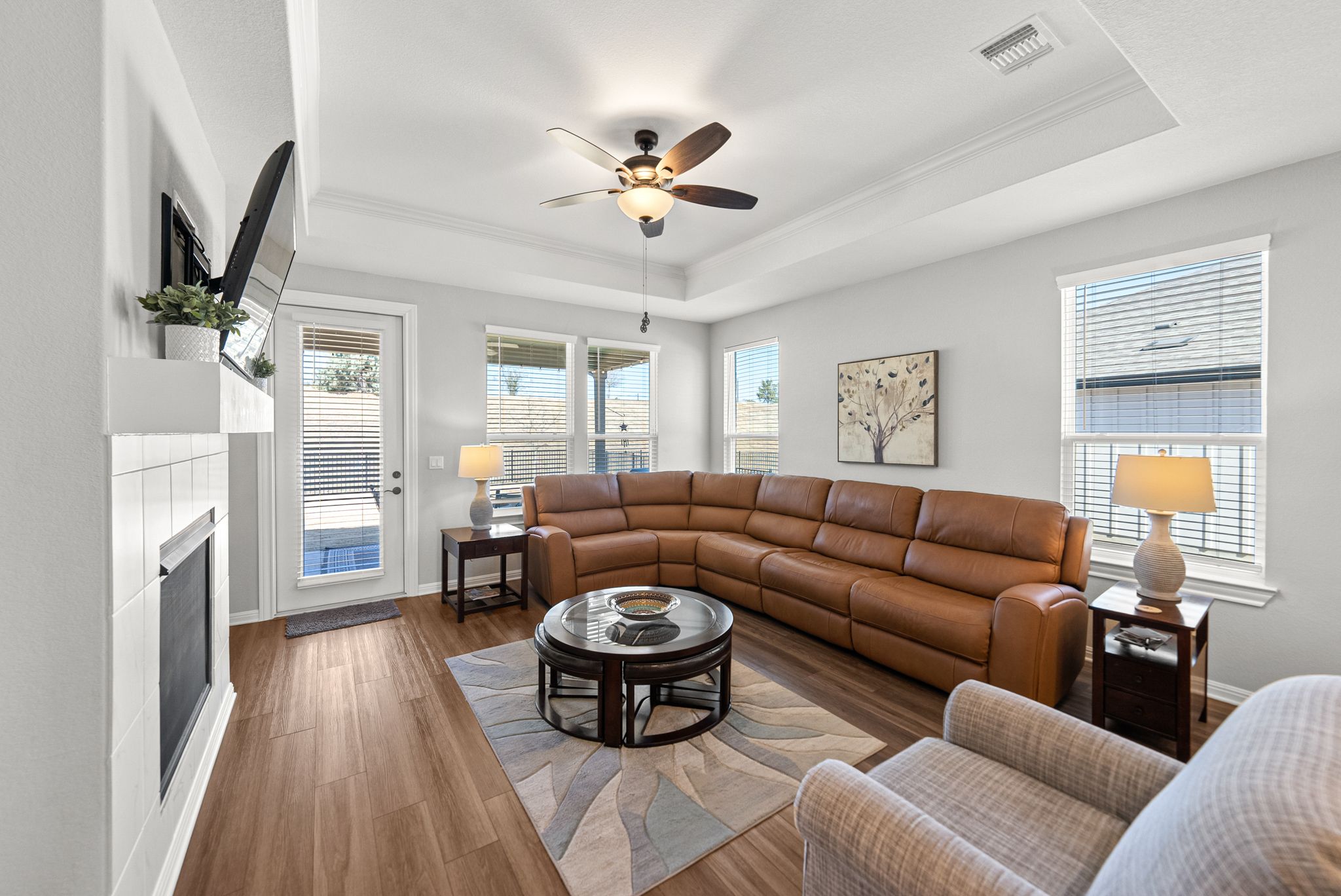 642 Martingale Street Georgetown, TX 78633 - Photo 17 of 40 The tray ceiling with crown molding adds an extra layer of design and height to the living area.
