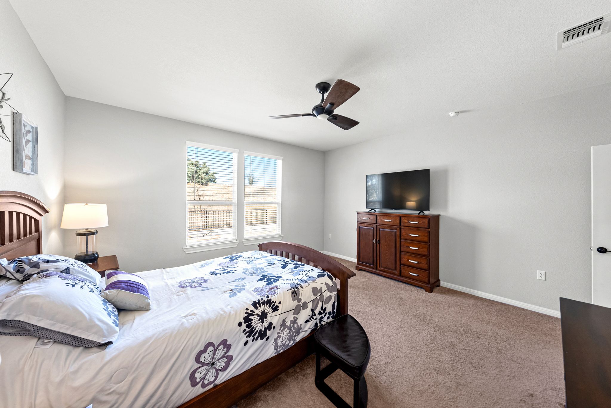 642 Martingale Street Georgetown, TX 78633 - Photo 19 of 40 Tucked off the main living area, this suite offers a neutral color palette that works with any decor. The smart layout provides plenty of wall space for a media console and dresser without feeling crowded.