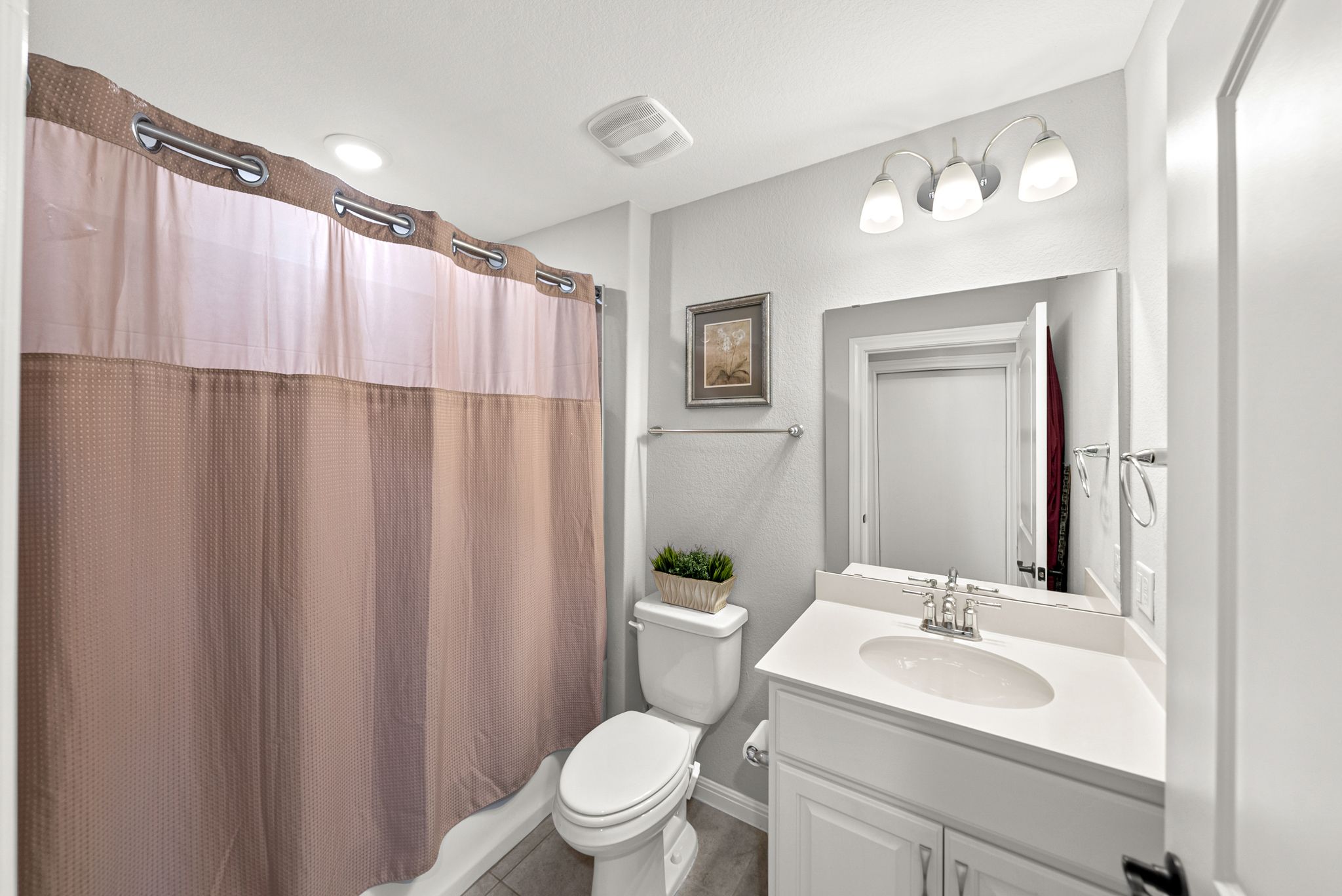 642 Martingale Street Georgetown, TX 78633 - Photo 26 of 40 The guest bath features a clean white vanity with modern fixtures ensuring your guests enjoy the same level of luxury found throughout the rest of the home.