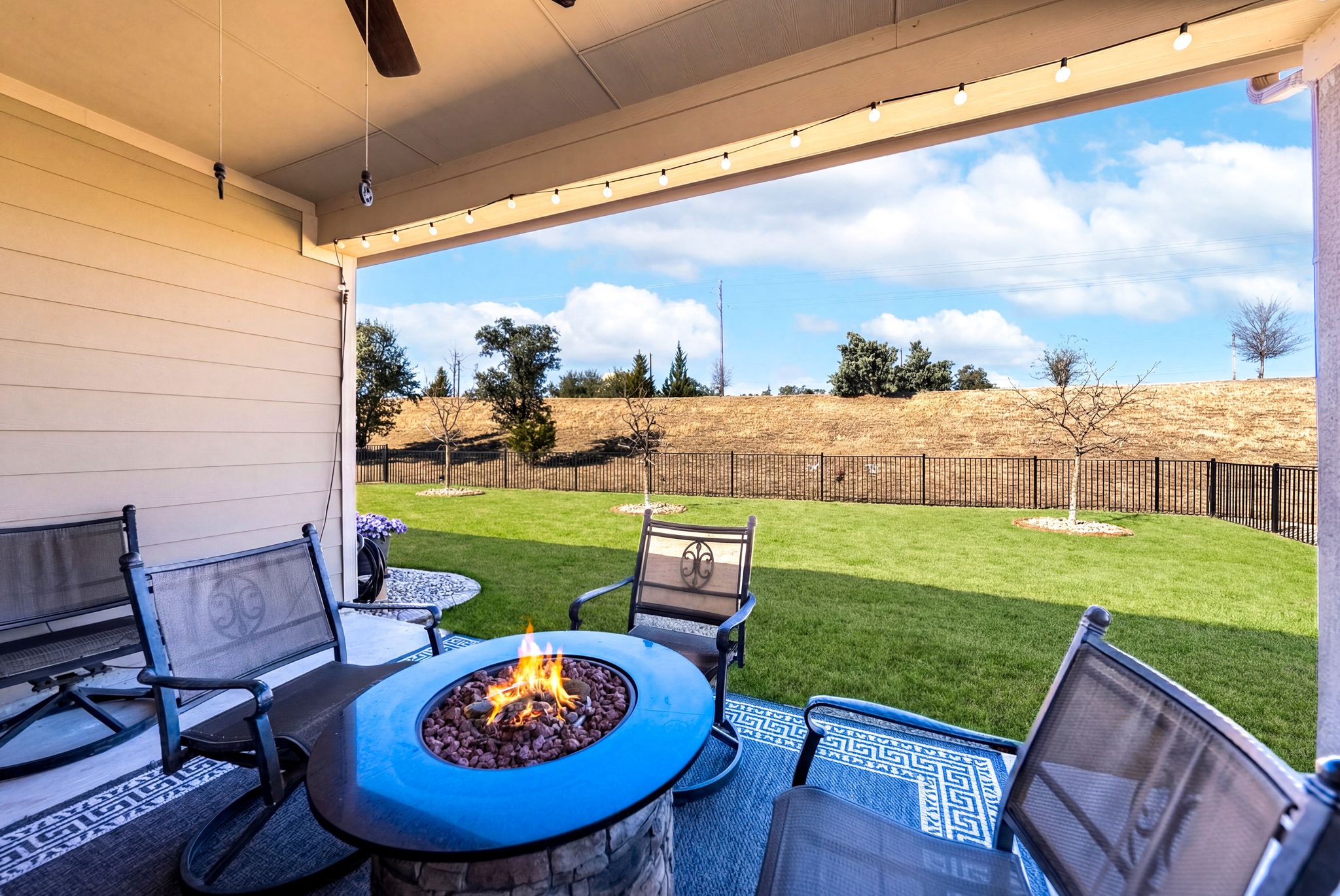 642 Martingale Street Georgetown, TX 78633 - Photo 36 of 40 Take in the fresh air in your private, fenced-in sanctuary. The patio overlooks a beautifully manicured lawn and a tranquil hillside, offering a peaceful backdrop for relaxation.