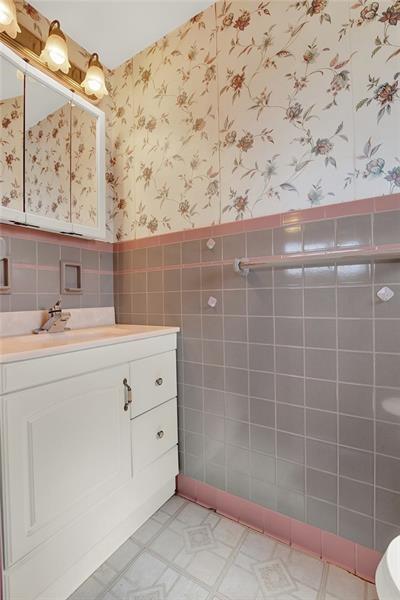 1409 Gill Hall Road Clairton, PA 15025 - Photo 13 of 29 a bathroom with a sink a vanity and a mirror
