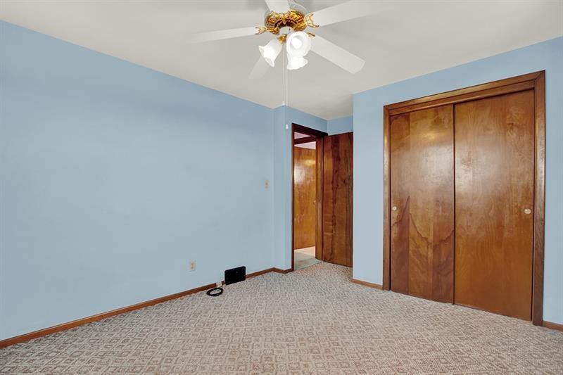 1409 Gill Hall Road Clairton, PA 15025 - Photo 15 of 29 an empty room with closet and a chandelier fan