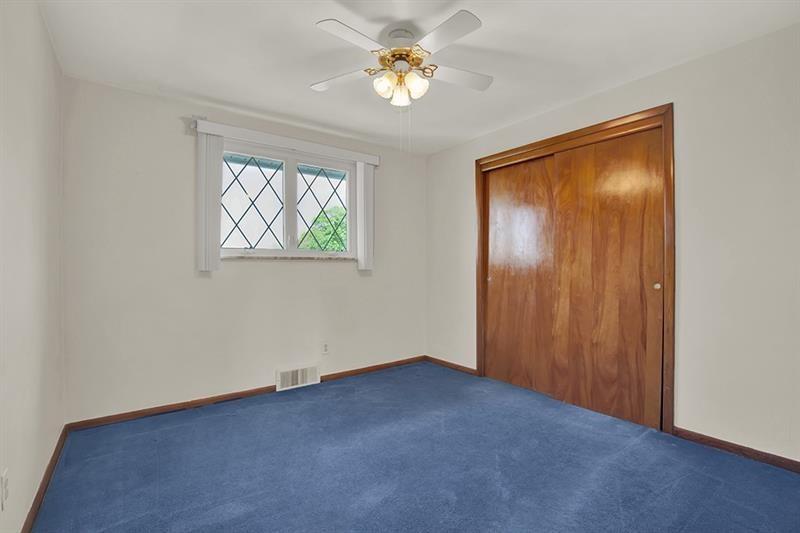 1409 Gill Hall Road Clairton, PA 15025 - Photo 16 of 29 an empty room with windows and fan