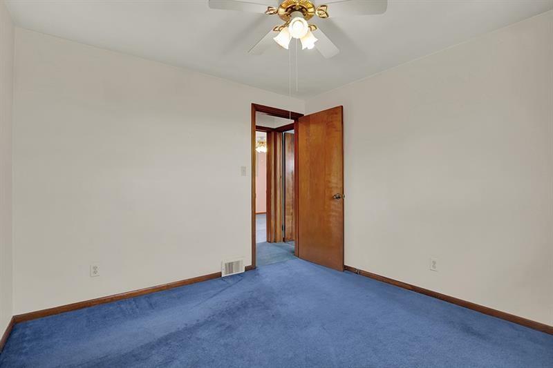 1409 Gill Hall Road Clairton, PA 15025 - Photo 17 of 29 an empty room with a chandelier fan