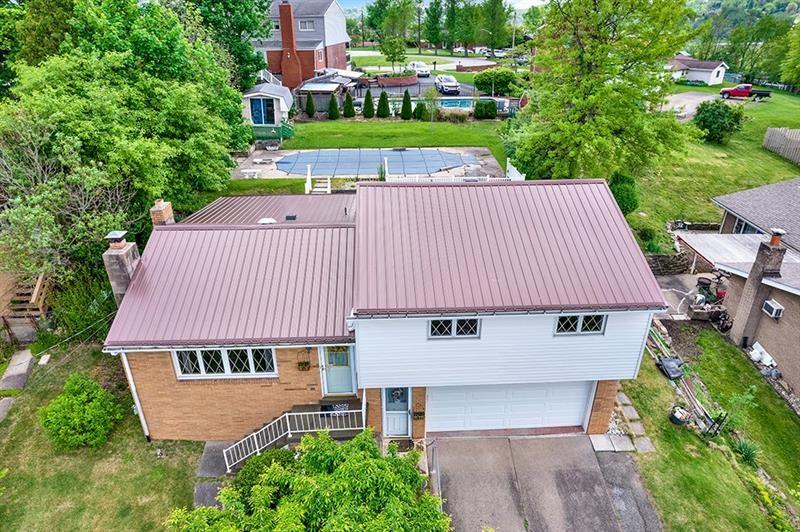 1409 Gill Hall Road Clairton, PA 15025 - Photo 2 of 29 an aerial view of a house with yard and trees in the background