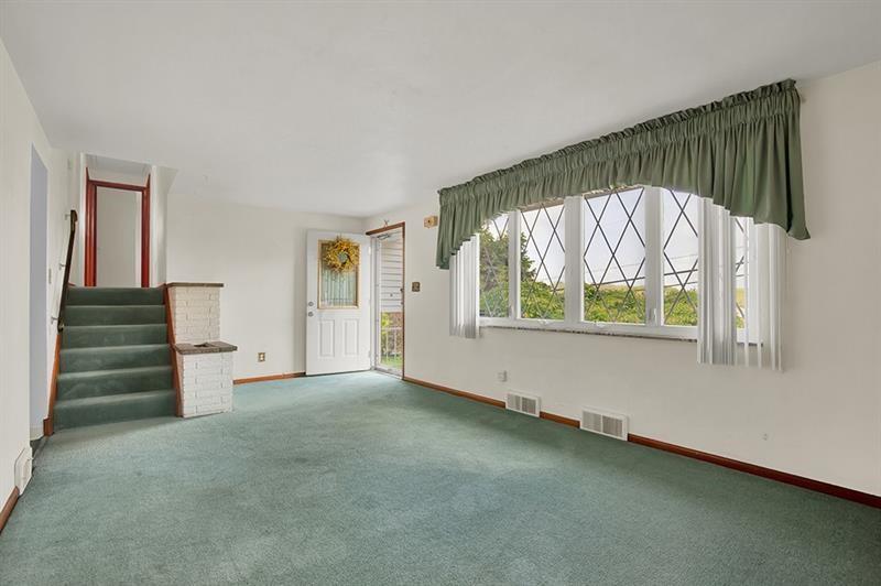 1409 Gill Hall Road Clairton, PA 15025 - Photo 4 of 29 an empty room with a window and a ceiling fan