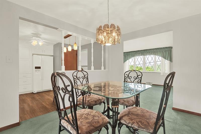 1409 Gill Hall Road Clairton, PA 15025 - Photo 6 of 29 a view of a dining room with furniture a chandelier and wooden floor