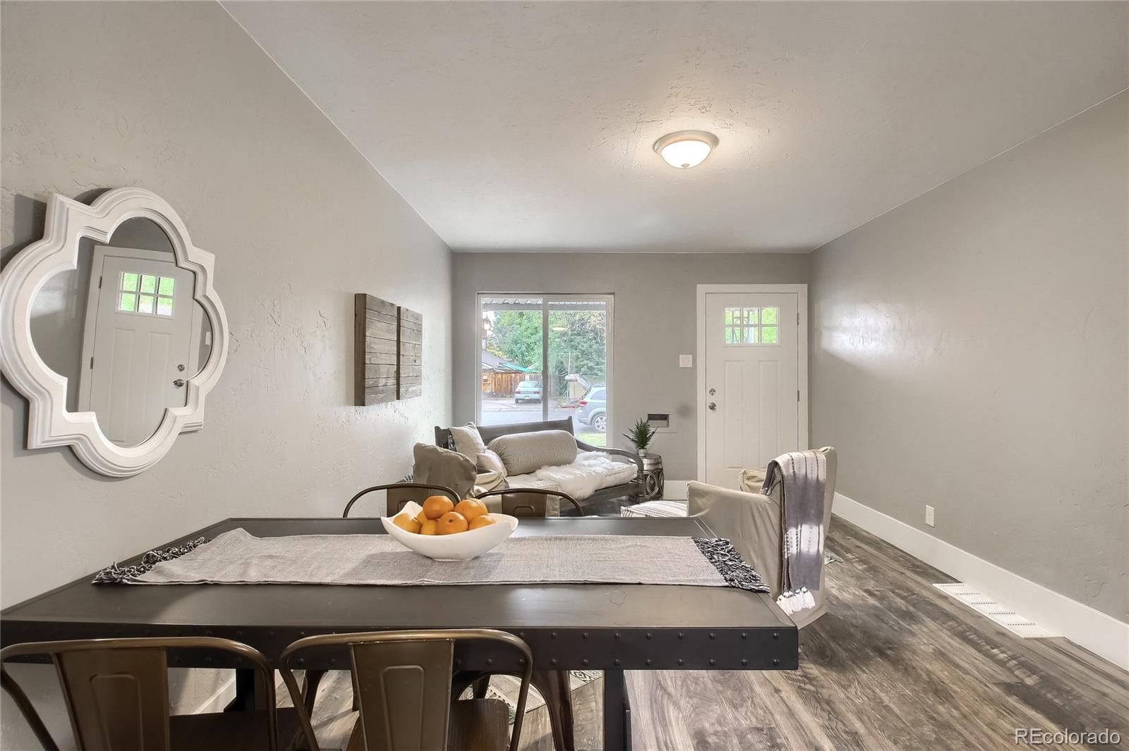 2821 Harrison Street Denver, CO 80205 - Photo 12 of 24 a view of a dining room with furniture and wooden floor