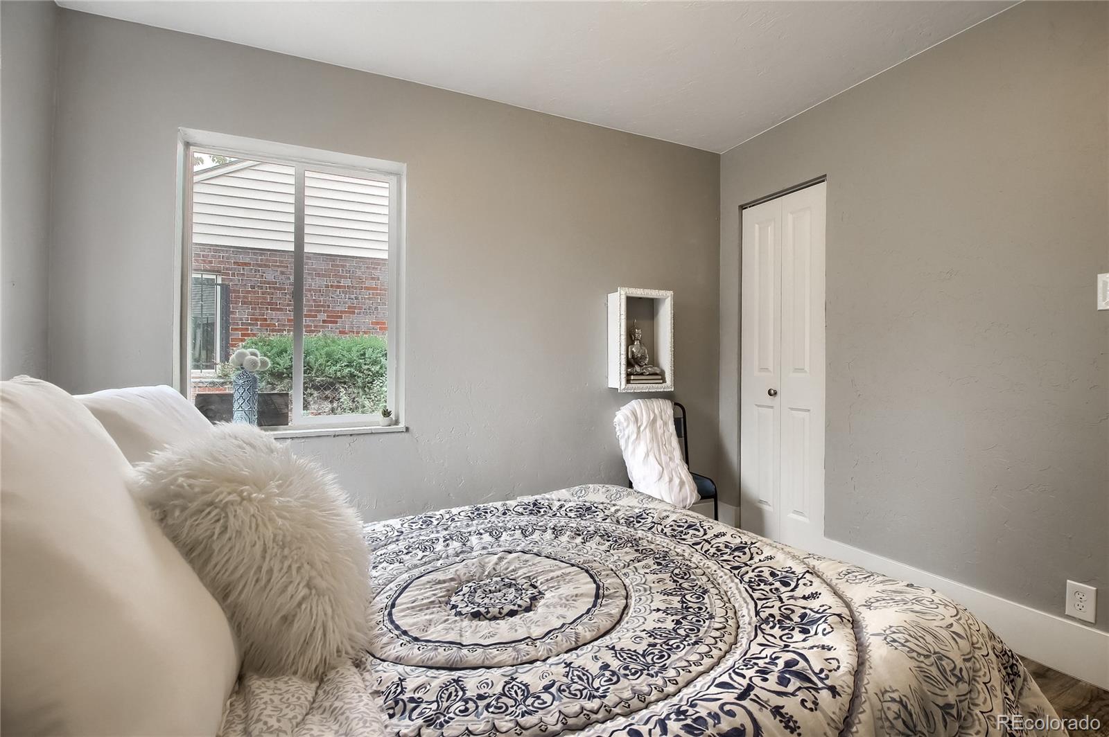 2821 Harrison Street Denver, CO 80205 - Photo 13 of 24 a bedroom with a bed and a window