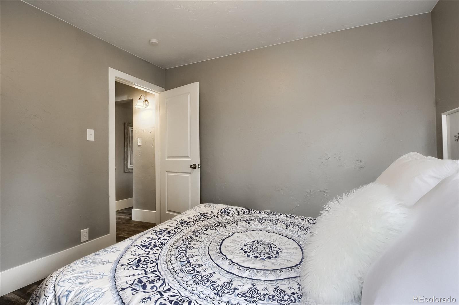 2821 Harrison Street Denver, CO 80205 - Photo 15 of 24 a bedroom with a bed and a table
