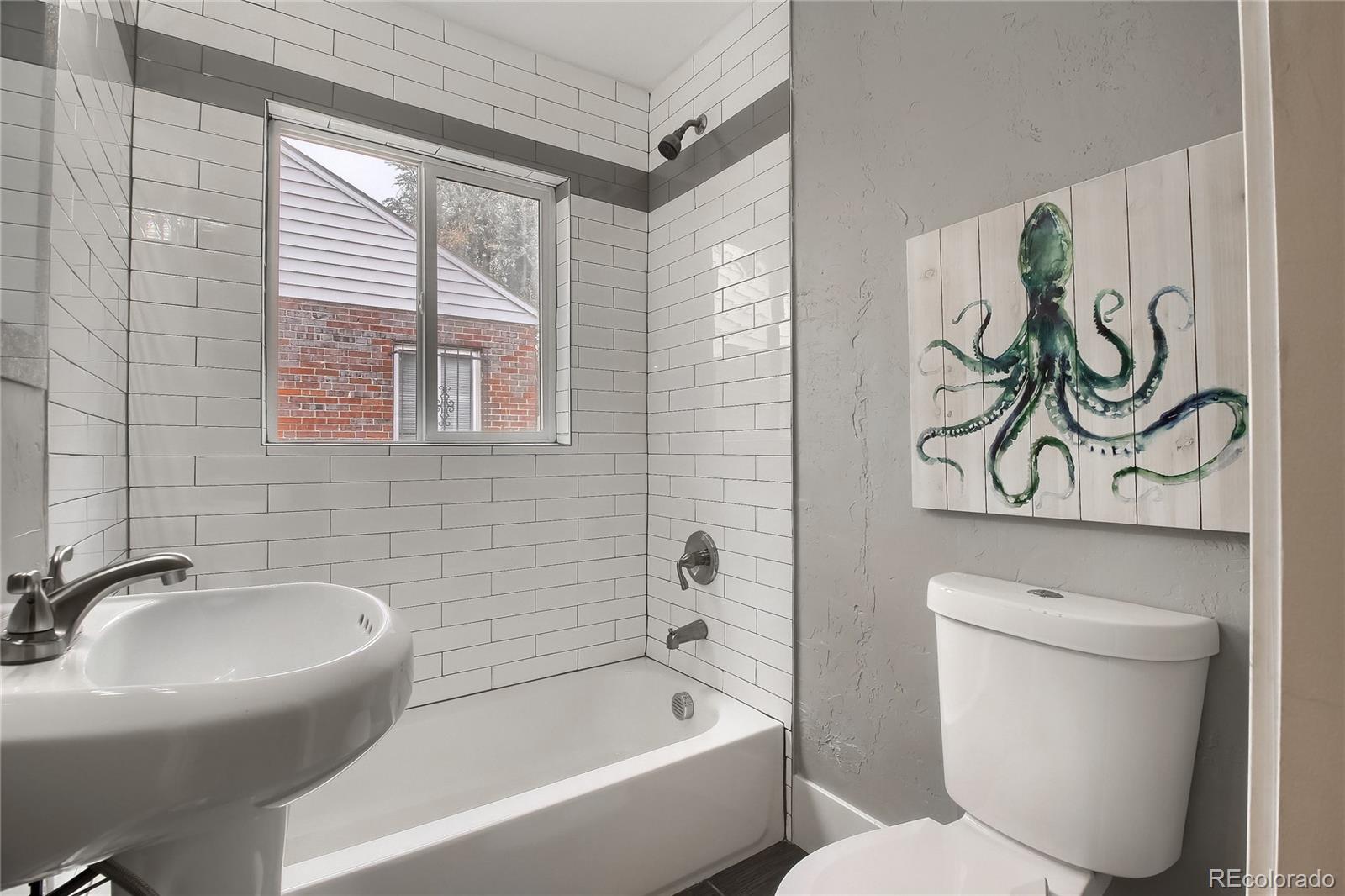 2821 Harrison Street Denver, CO 80205 - Photo 16 of 24 a bathroom with a toilet sink and bathtub