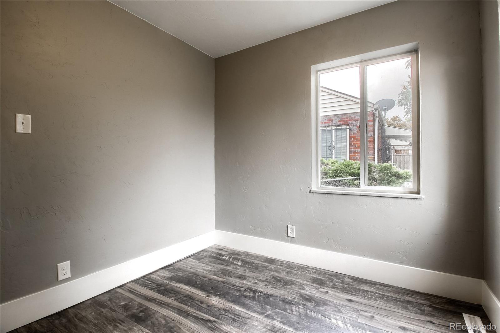 2821 Harrison Street Denver, CO 80205 - Photo 19 of 24 a view of a bedroom with wooden floor and a window