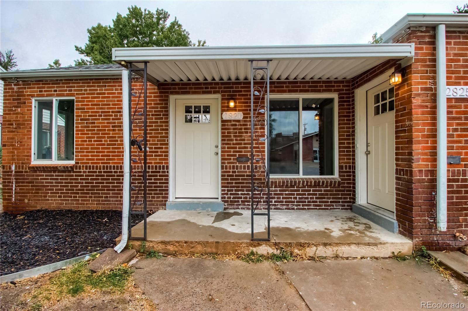 2821 Harrison Street Denver, CO 80205 - Photo 2 of 24 a front view of a house