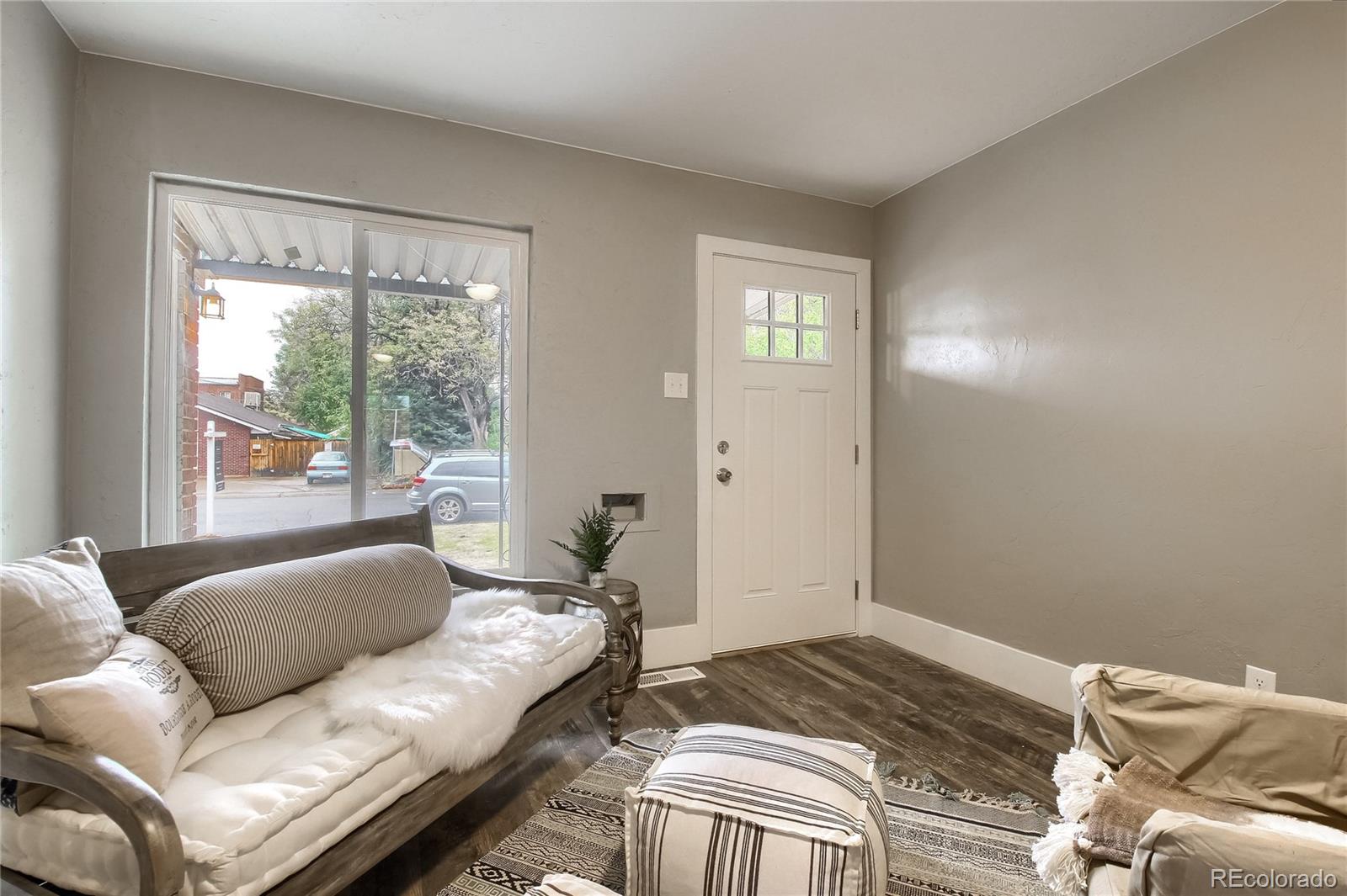 2821 Harrison Street Denver, CO 80205 - Photo 4 of 24 a bedroom with a couch and a window