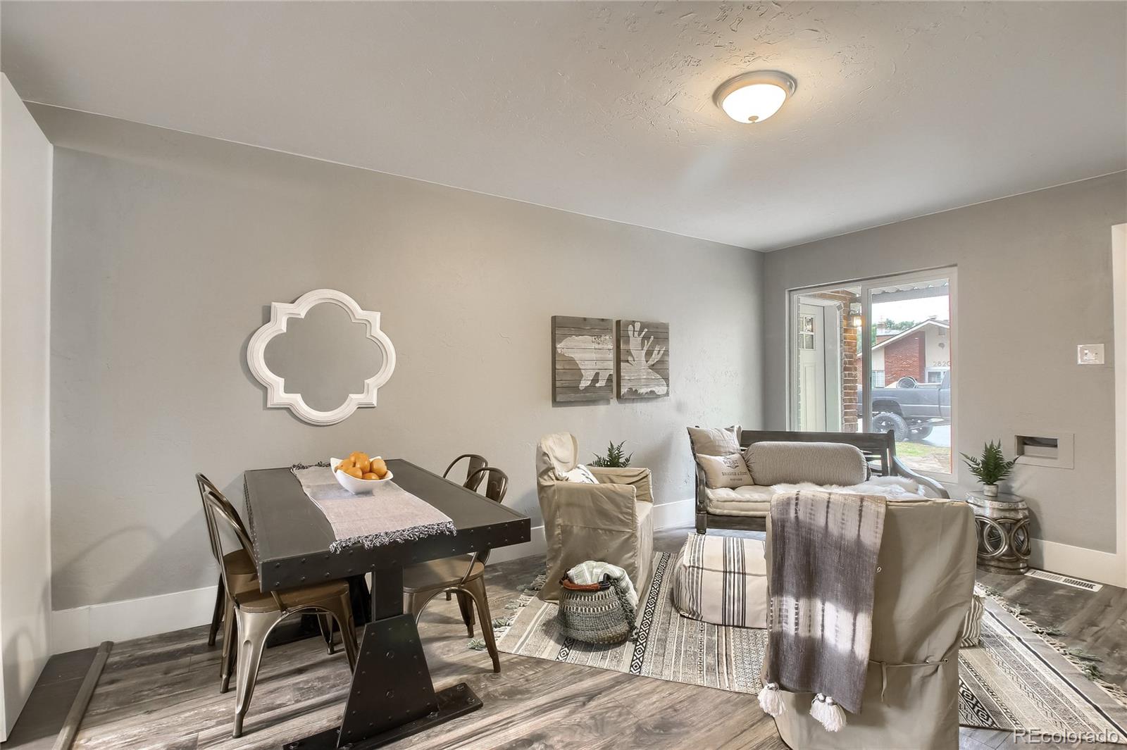 2821 Harrison Street Denver, CO 80205 - Photo 10 of 24 a living room with furniture dining table and a large window