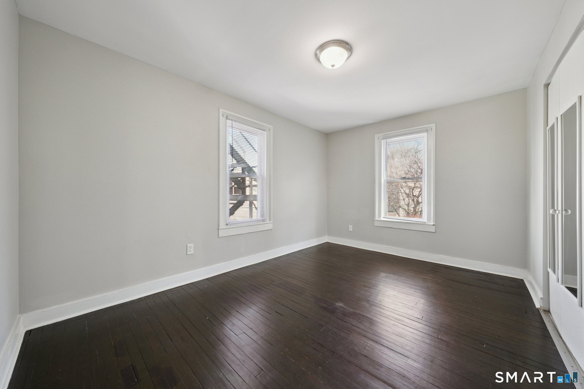 73 Orange Street Bridgeport, CT 06607 - Photo 16 of 33 a view of an empty room with wooden floor and a window