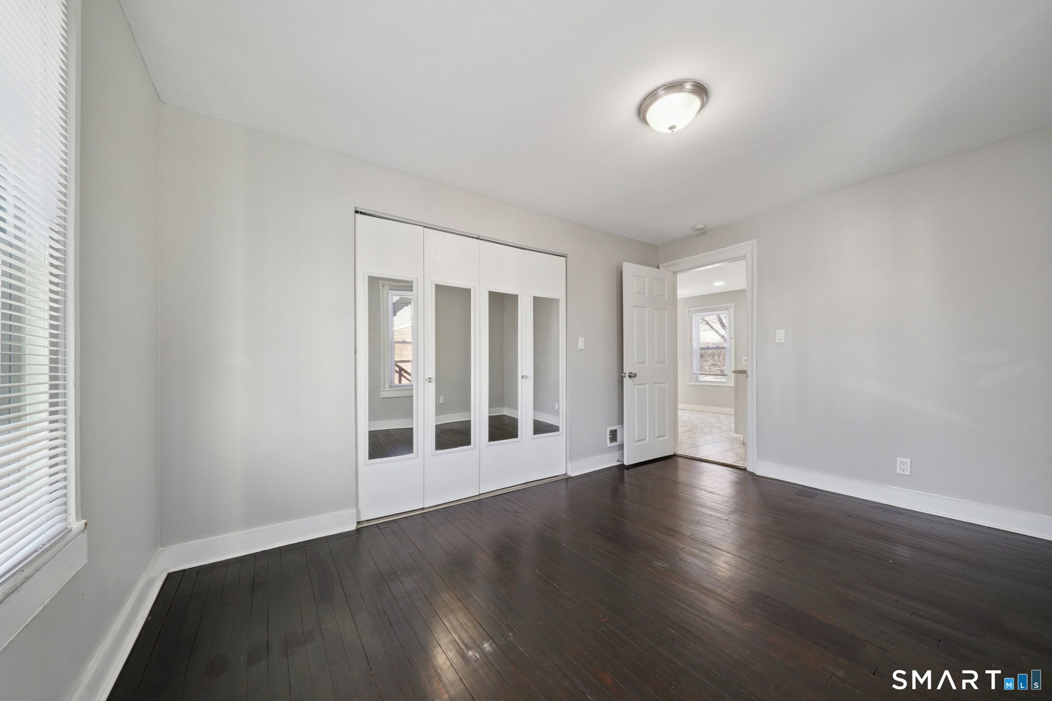 73 Orange Street Bridgeport, CT 06607 - Photo 17 of 33 a view of an empty room with wooden floor and a window