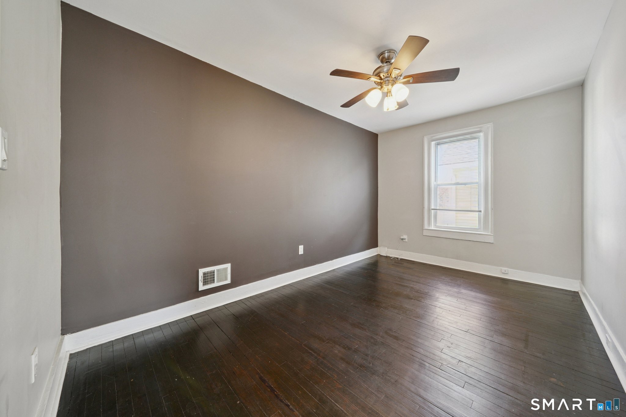 73 Orange Street Bridgeport, CT 06607 - Photo 18 of 33 an empty room with wooden floor fan and windows