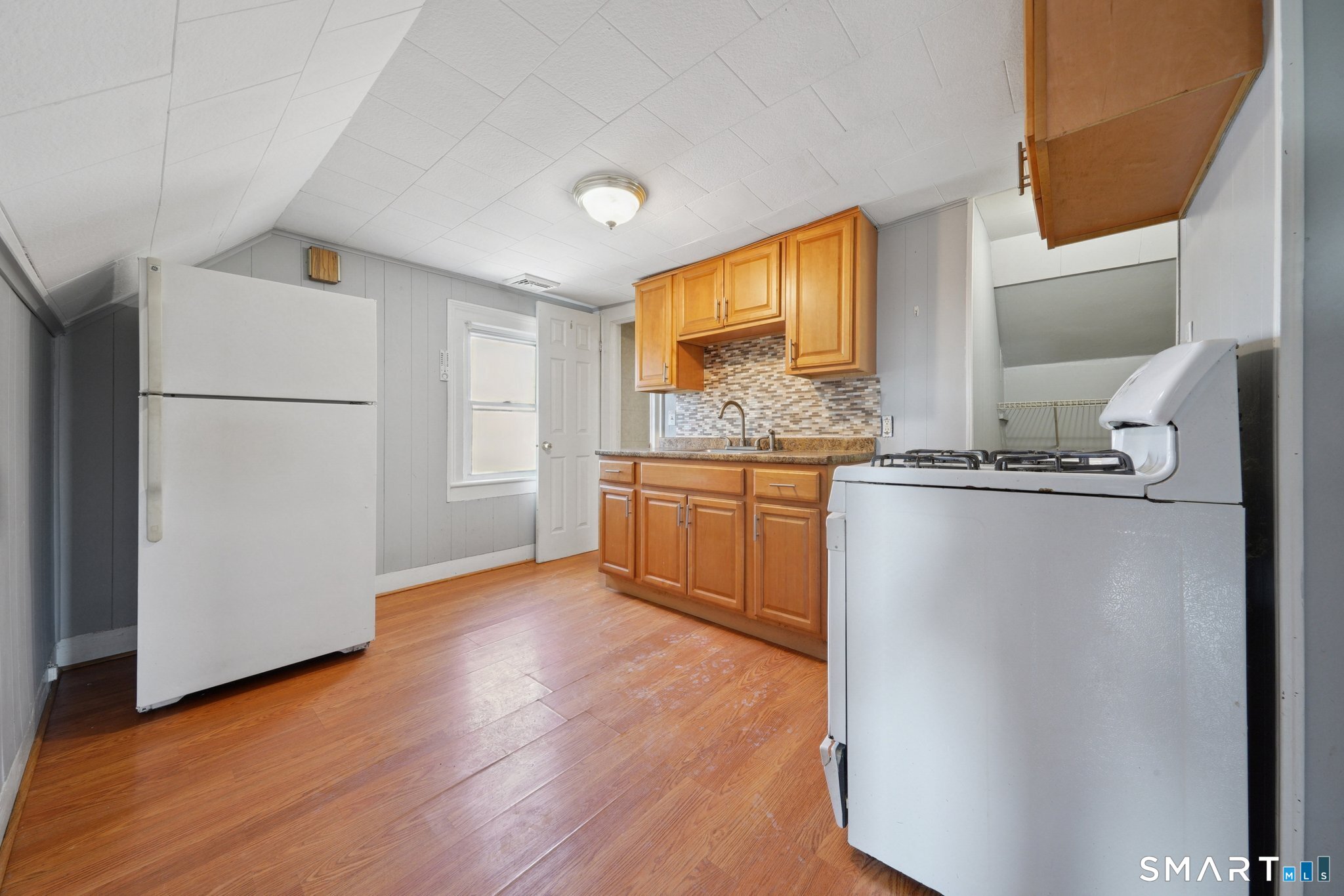 73 Orange Street Bridgeport, CT 06607 - Photo 25 of 33 a kitchen with stainless steel appliances granite countertop a refrigerator a sink and a stove