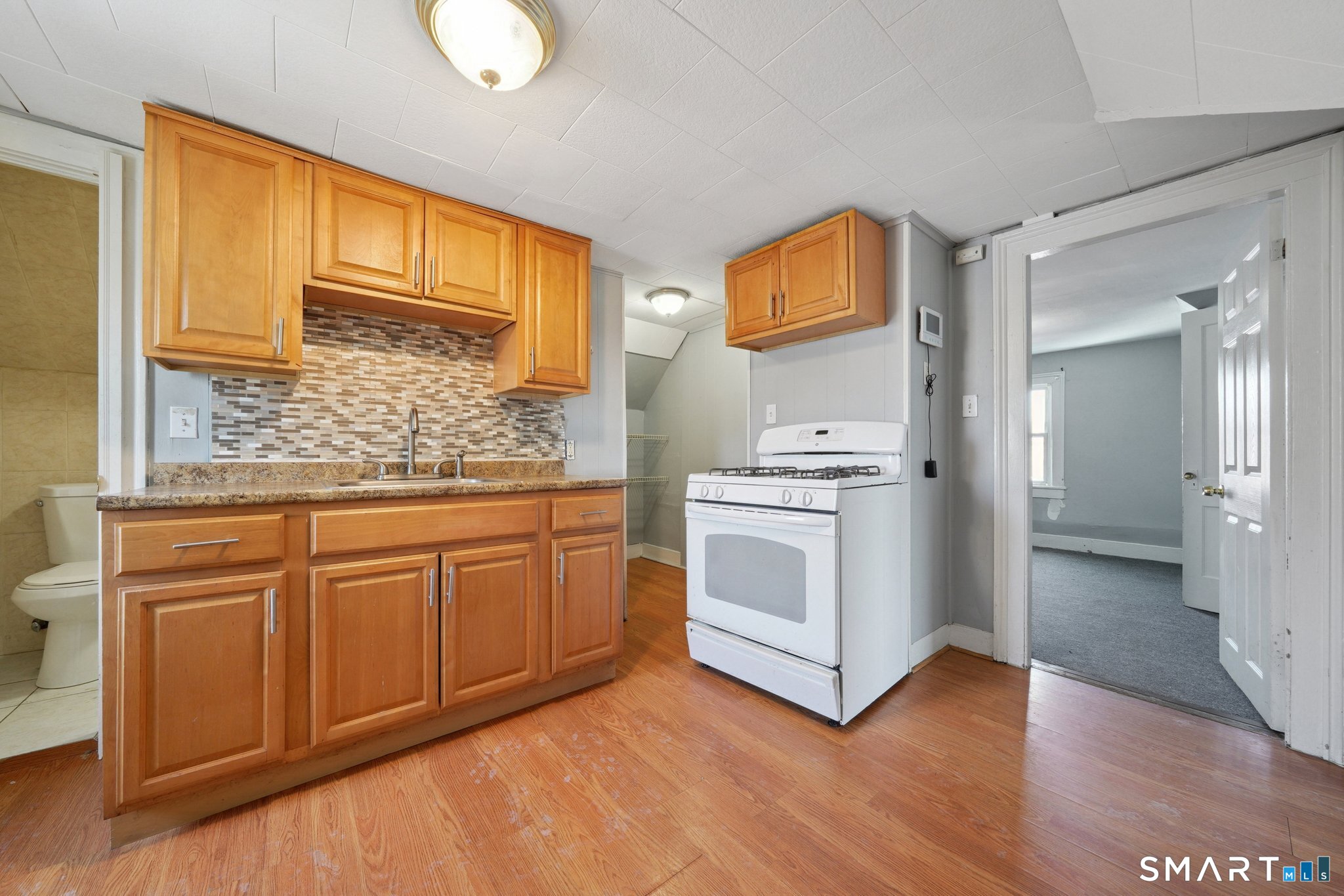 73 Orange Street Bridgeport, CT 06607 - Photo 26 of 33 a kitchen with stainless steel appliances granite countertop a stove a sink and a refrigerator