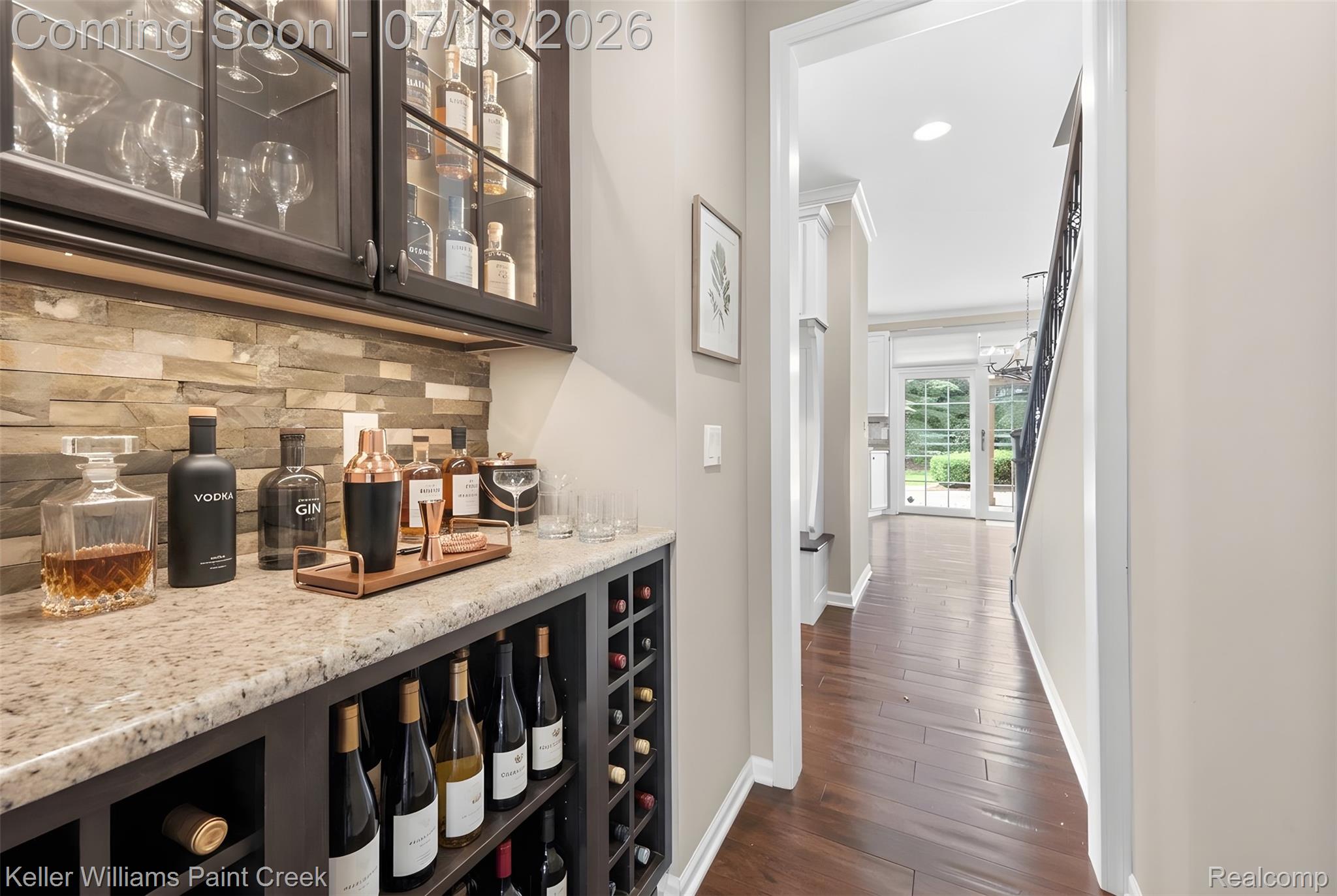 4230 Holly Lane Rochester, MI 48306 - Photo 12 of 64 Built-in bar area featuring stacked stone backsplash, granite countertop, rich wood cabinetry with glass doors, and integrated wine storage
