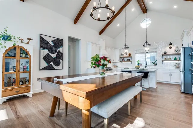 a large kitchen with a table and chairs