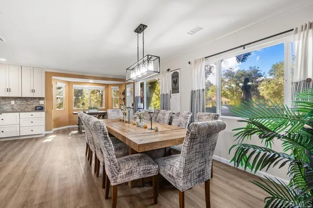 a living room with furniture flat screen tv and a large window