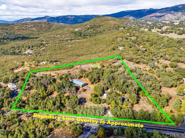 a kitchen with stainless steel appliances granite countertop a refrigerator a stove and a wooden floors