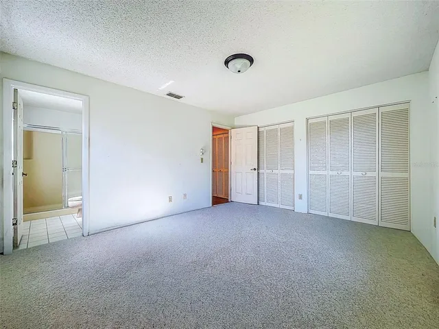 an empty room with a empty space and windows