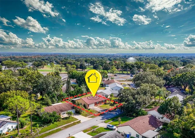a view of a swimming pool with a table and chairs in patio