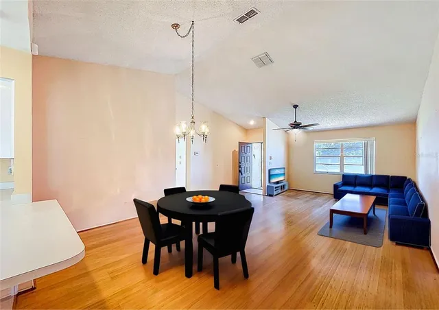 a view of a dining room with furniture and wooden floor
