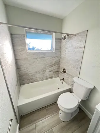 a bathroom with a toilet a sink and a bathtub