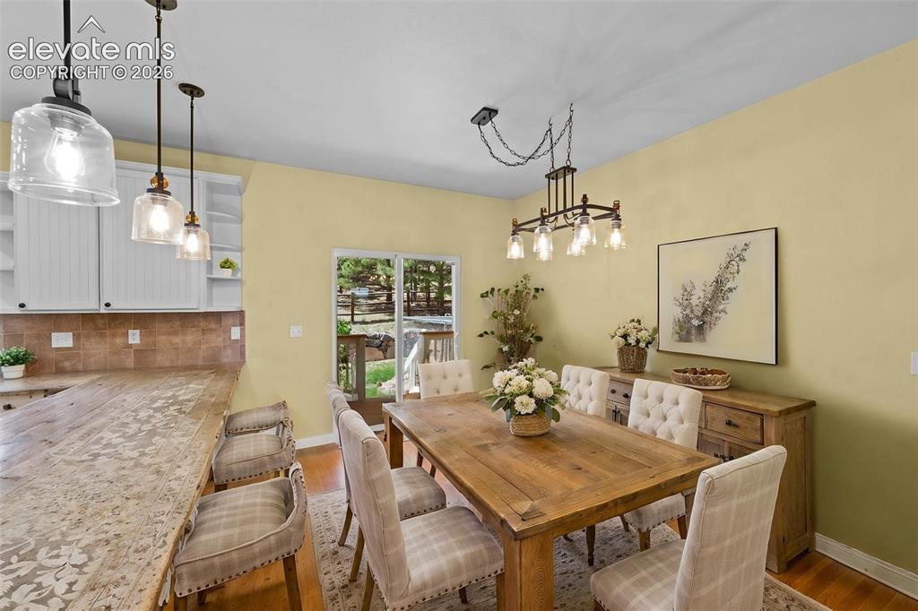 16540 Mesquite Road Peyton, CO 80831 - Photo 15 of 50 a view of a dining room with furniture window and wooden floor
