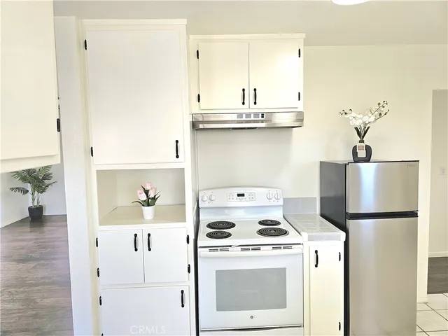 a kitchen with a stove and a refrigerator