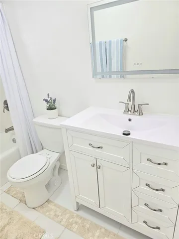 a bathroom with a sink toilet and vanity
